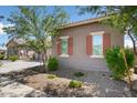 Side view of the home showcasing its stucco exterior and landscaping at 16747 W Cielo Grande Ave, Surprise, AZ 85387