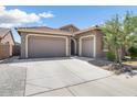 Two-story home with a three-car garage and well-manicured lawn at 16747 W Cielo Grande Ave, Surprise, AZ 85387