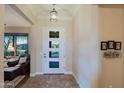 Bright and airy entryway with a modern door and tiled floors at 17716 E Silver Sage Ln, Rio Verde, AZ 85263