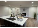 Bright dining area with white brick fireplace and hardwood floors at 1936 E Cornell Dr, Tempe, AZ 85283