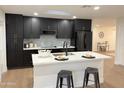 Modern kitchen with dark cabinetry, white countertops, and island at 1936 E Cornell Dr, Tempe, AZ 85283