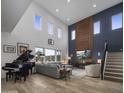 Spacious living room with high ceilings, grand piano, and modern fireplace at 22034 N 59Th Pl, Phoenix, AZ 85054