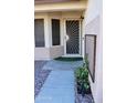 Front entry with decorative security door and sidelights at 22233 N 76Th Dr, Peoria, AZ 85383