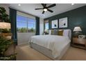 Spacious bedroom with large windows and a ceiling fan at 22343 W Monona Ln, Surprise, AZ 85387