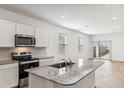 Modern kitchen with granite countertops and breakfast bar at 25359 W Sunland Ave, Buckeye, AZ 85326