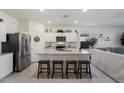 Modern kitchen with white cabinets, granite island, and stainless steel appliances at 25587 N Boreas Rd, Florence, AZ 85132