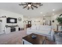 Living room with beige carpet, sofa, coffee table, and ceiling fan at 25587 N Boreas Rd, Florence, AZ 85132