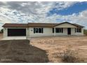 Newly built home with a two-car garage and neutral color scheme at 25603 W Hedgehog Rd, Wittmann, AZ 85361