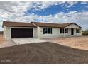 New single-story home with attached garage, neutral exterior, and desert landscaping at 25603 W Hedgehog Rd, Wittmann, AZ 85361