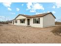 Single-story home with neutral color palette and charming curb appeal at 25603 W Hedgehog Rd, Wittmann, AZ 85361