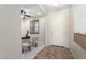 Bright and airy entryway with tile flooring and a view into a home office at 26637 W Irma Ln, Buckeye, AZ 85396