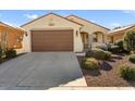 Front view of a charming house with a brown garage door at 26637 W Irma Ln, Buckeye, AZ 85396