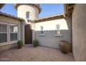 Private courtyard entry with brick pavers and potted plants at 28548 N 68Th Ave, Peoria, AZ 85383