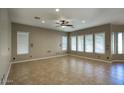 Spacious living room with tile floors and large windows at 28548 N 68Th Ave, Peoria, AZ 85383