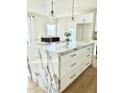 Spacious kitchen island featuring a white marble countertop, cabinets and gold handles at 4032 N 11Th Ave, Phoenix, AZ 85013