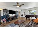 Spacious living room featuring hardwood floors and a piano at 4048 W Sierra Vista Dr, Phoenix, AZ 85019