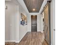 Entryway with barn door and wood-look floors at 44622 N Sonoran Arroyo Ln, New River, AZ 85087