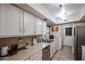 Clean and functional kitchen with white cabinets and updated sink at 4539 W Mclellan Rd, Glendale, AZ 85301