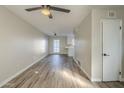 Open concept living room with laminate flooring and access to the kitchen at 4565 N 26Th Dr, Phoenix, AZ 85017