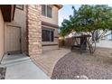 Front entry with stone accents and a relaxing patio swing at 494 S 220Th Ln, Buckeye, AZ 85326