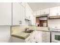 Small kitchen with white cabinets and green tile at 5331 E Virginia Ave, Phoenix, AZ 85008