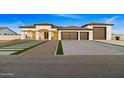 Modern three-car garage home with a spacious driveway at 6105 N 174Th Ave, Waddell, AZ 85355