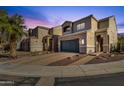 Two-story house with a dark-gray garage door and desert landscaping at 8137 N 13Th Pl, Phoenix, AZ 85020