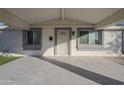 Covered entryway with a tiled porch and security door at 8230 W Monterey Way, Phoenix, AZ 85033