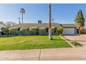 Single story home with a spacious lawn and attached garage at 8435 E Catalina Dr, Scottsdale, AZ 85251