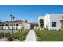 White stucco home with red tile roof and lush landscaping at 8601 N 64Th Pl, Paradise Valley, AZ 85253