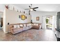 Spacious living room with a large sectional sofa and tile flooring at 8828 E Des Moines St, Mesa, AZ 85207