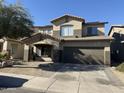 Two-story house with a brown garage door and a landscaped front yard at 9420 S 35Th Gln, Laveen, AZ 85339