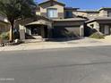 Two-story house with a brown garage door and a landscaped front yard at 9420 S 35Th Gln, Laveen, AZ 85339