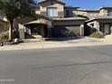 Two-story house with a brown garage door and a landscaped front yard at 9420 S 35Th Gln, Laveen, AZ 85339