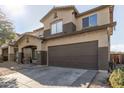 Two-story house with a brown garage door and desert landscaping at 9420 S 35Th Gln, Laveen, AZ 85339