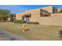 Tan stucco house with a tiled entryway, fire hydrant, and grassy area at 948 S Alma School Rd Rd # 89, Mesa, AZ 85210