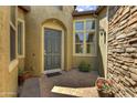 Inviting front entrance with a dark-grey door and a stone-paved patio at 12617 W Mine Trl, Peoria, AZ 85383