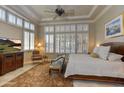 Spacious main bedroom with large windows, a sitting area, and a king-size bed at 12617 W Mine Trl, Peoria, AZ 85383