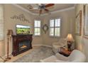 Cozy sitting area with a fireplace, comfortable chairs, and large windows at 12617 W Mine Trl, Peoria, AZ 85383