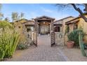 Elegant gated entry to a beautiful stone home at 14705 E Redbird Rd, Scottsdale, AZ 85262