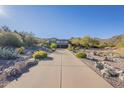 This property boasts a large driveway and is nestled in a desert landscape at 14944 E Zapata Dr, Fountain Hills, AZ 85268