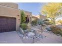 Front entry with desert landscaping and a two-car garage at 14944 E Zapata Dr, Fountain Hills, AZ 85268