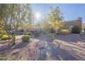 A tan stucco house with a two-car garage sits on a rocky hillside at 14944 E Zapata Dr, Fountain Hills, AZ 85268