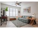 Living room with gray couch, wood floors, and plantation shutters at 1720 E Thunderbird Rd # 1111, Phoenix, AZ 85022