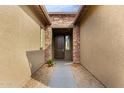 Front entry with stone detailing and a dark brown door at 18934 W Sierra St, Surprise, AZ 85388