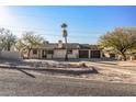 Single story home with attached two-car garage and desert landscaping at 2070 N Don Peralta Rd, Apache Junction, AZ 85119