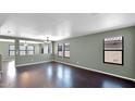 Bright living room with dark hardwood floors and neutral walls at 219 E Beth Dr, Phoenix, AZ 85042