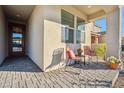 Inviting front porch with seating area and modern design at 22846 E Watford Dr, Queen Creek, AZ 85142