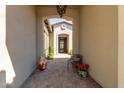 Inviting entryway with arched opening and decorative wrought iron door at 31023 N 117Th Dr, Peoria, AZ 85383