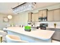 Modern kitchen with light cabinets and quartz countertops at 42206 W Capistrano Dr, Maricopa, AZ 85138